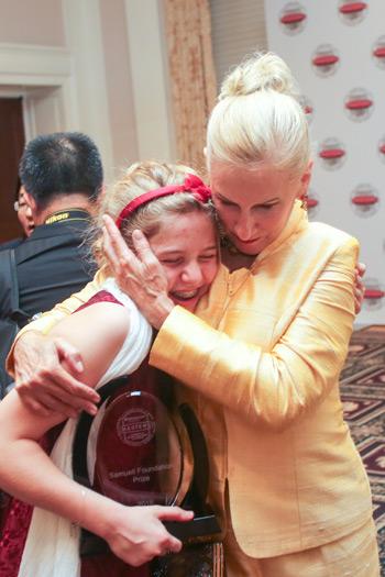 Broadcom Foundation President Paula Golden gives top winner Eleanor Sigrest congratulations and a big hug.