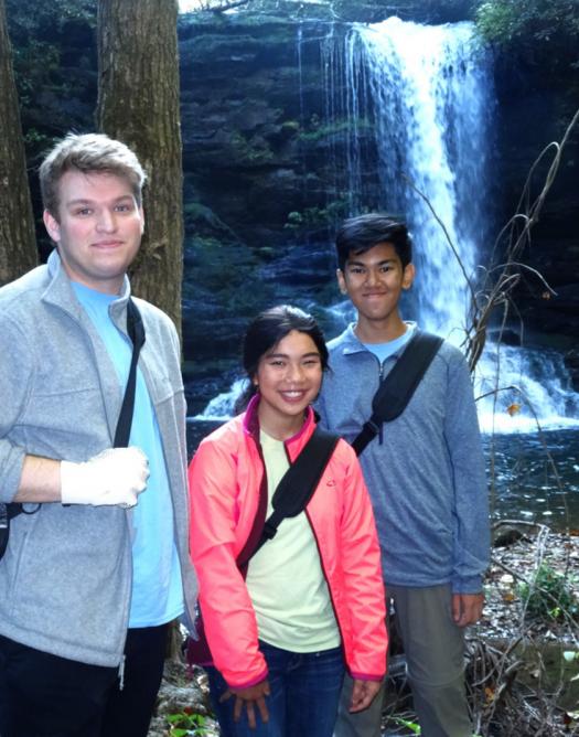 The students hiked down to a waterfall in order to collect spray cliff plants for their research project.