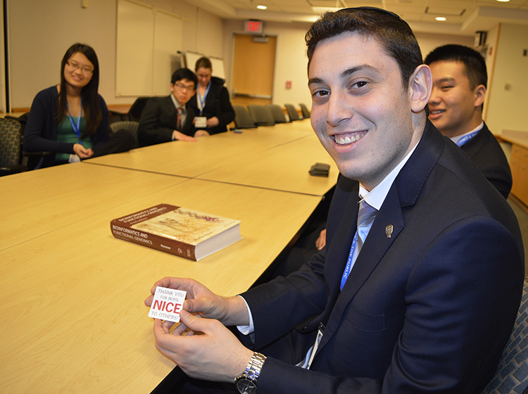 Finalist Asher Willner displays his sticker he won from Ben Busby's lab visit. PHOTO COURTESY OF SOCIETY FOR SCIENCE & THE PUBLIC/MARLENA CHERTOCK.