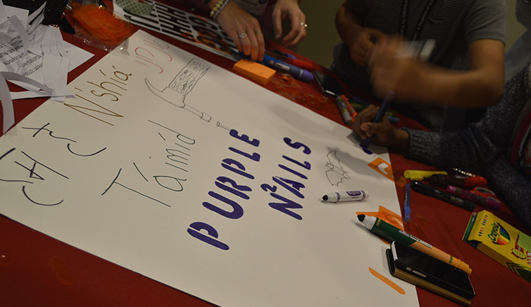 Members of the purple team designed their poster with their native languages saying Members of the purple team designed their poster with their native languages saying