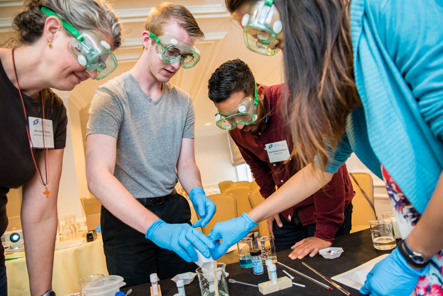 Elias Arellano Villanueva (second from right) works on a project with students and fellow Advocate Ellen Smith Tourigny (left) at the Advocate Training Institute in Washington, D.C.