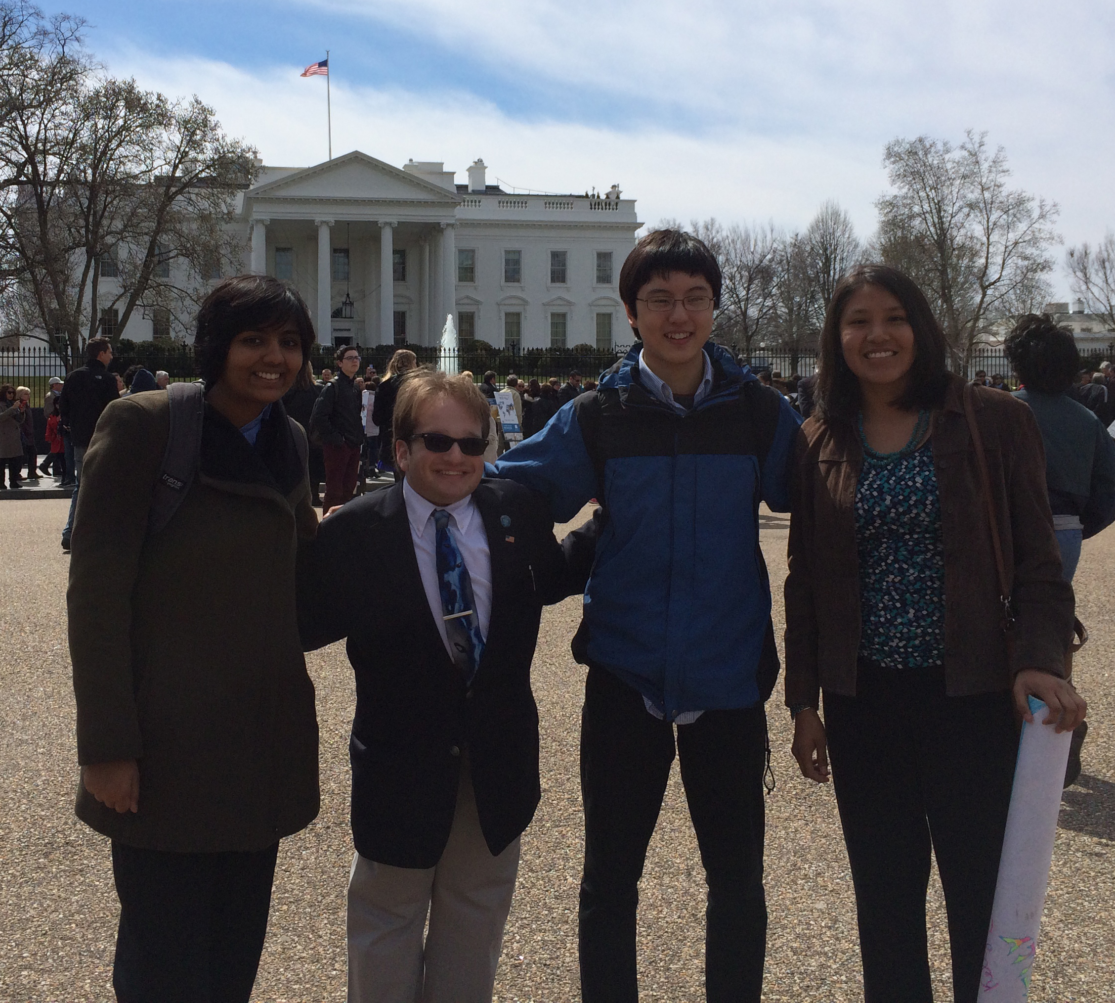 Anvita Gupta, Harry Paul. Nathan Han, and Kelly Charley in front of the White House.