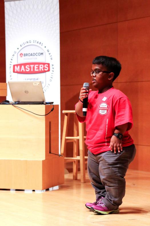 Heviinash Parugavelu, from Malaysia, shares his research project on water pollution with his peers.