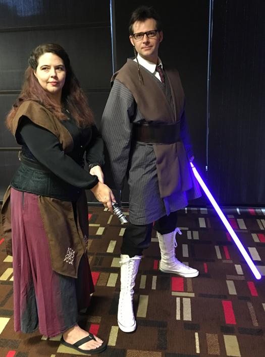 Astronomer Pamela Gay and engineering graduate student Ryan Consell cosplay as Jedis. Ryan is a mashup of Obi Wan and Dr. Who.