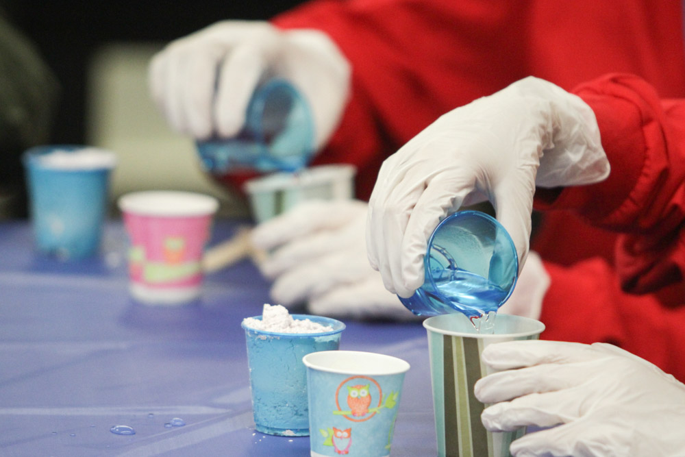 Delegates mixed dental stone to make casts of their thumbs.