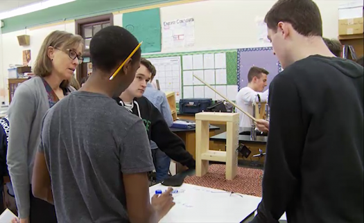 Janet Waldeck, left, watches as students participate in a lab using a lending kit. 