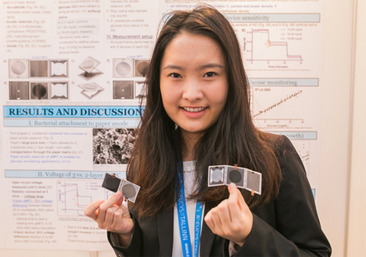 Kendra holds up her device prototypes at EUCYS.