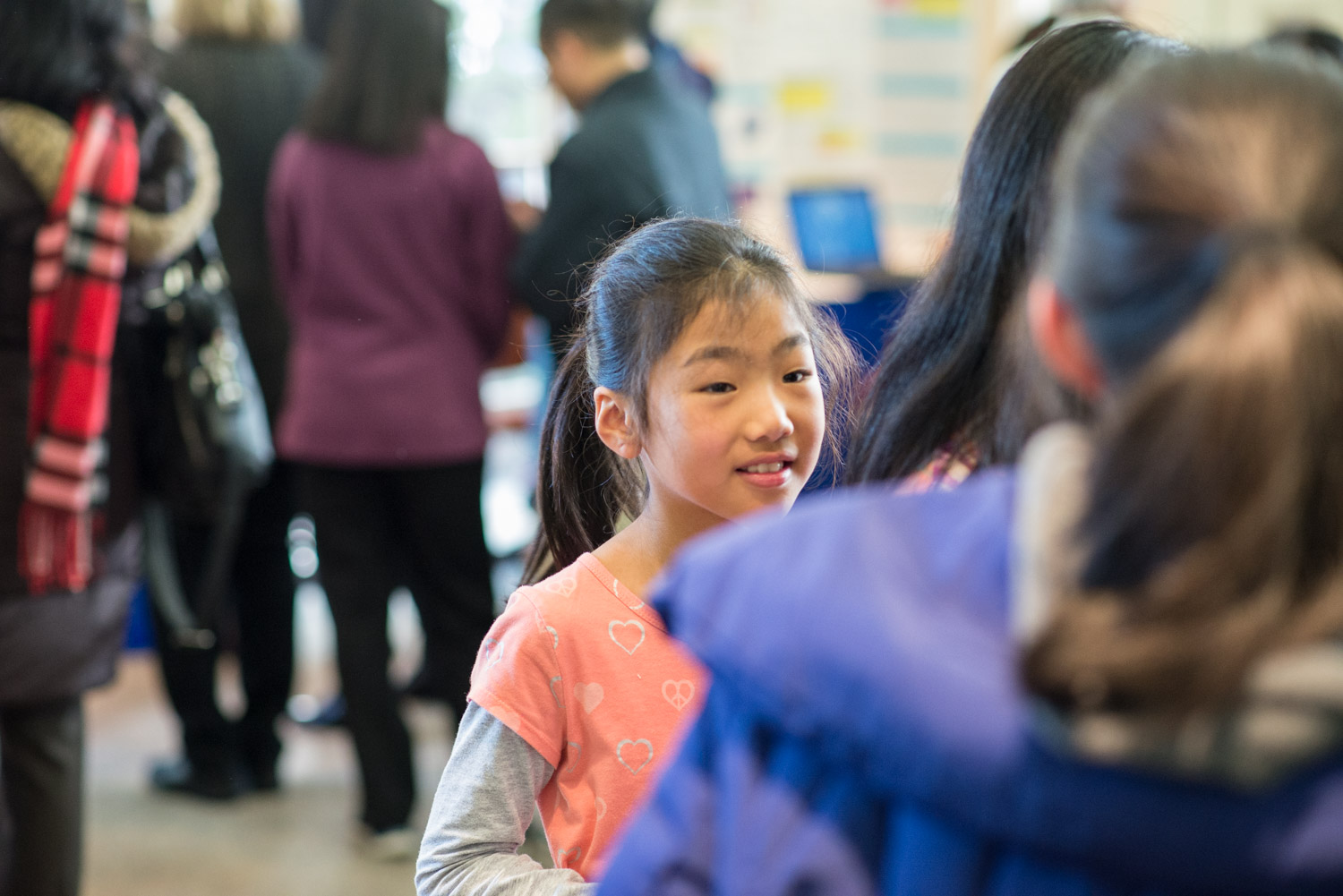 A young science enthusiast learns about a finalist's project.