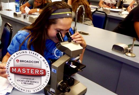 Madison studying a sample of horse blood under a microscope to identify various cells.