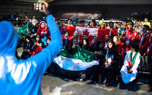 A big part of the opening ceremony is sharing country pride. The Intel ISEF 2018 finalists hold up flags and posters.