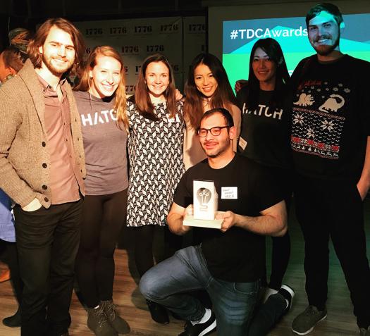 The Hatch Apps team hold up an award.