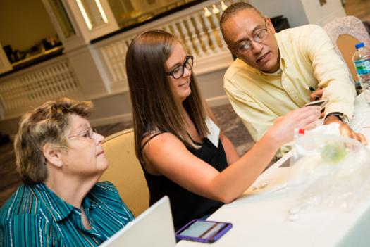 From left to right, Marteen Nolen, Shana Lee, and Conrad Faine work on an activity at the Advocate Training Institute.