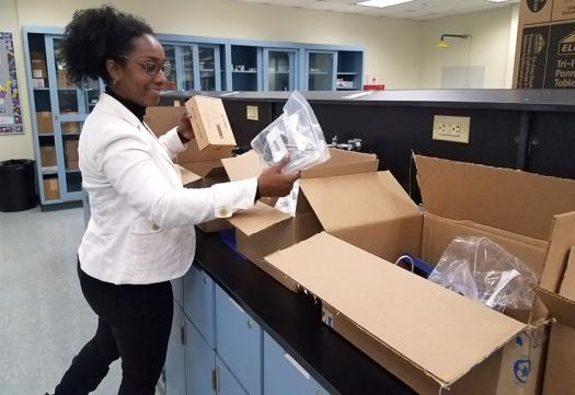 Tahnee Harrell unpacking boxes of equipment when it arrives at the school. This equipment greatly enhanced the individual and group research projects that students are required to carry out.