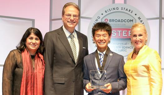 Kaien holds up his award with President & CEO of the Society Maya Ajmera (left), Co-founder of the Broadcom Foundation Henry Samueli, and President of the Broadcom Foundation Paula Golden.