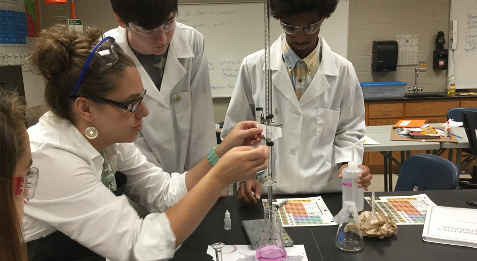 Teacher and kids with science experiment