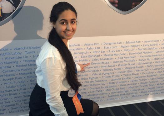 Deena points to her name at Intel ISEF 2013. Photo courtesy of Deena Mousa.