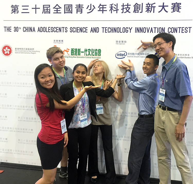 Intel ISEF finalists stand in front of a China Adolescent Science & Technology Innovation Contest Intel sign.