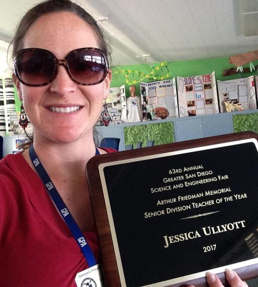 Jessica Ullyott holds up her Senior Teacher of the Year Award that her students nominated her for.
