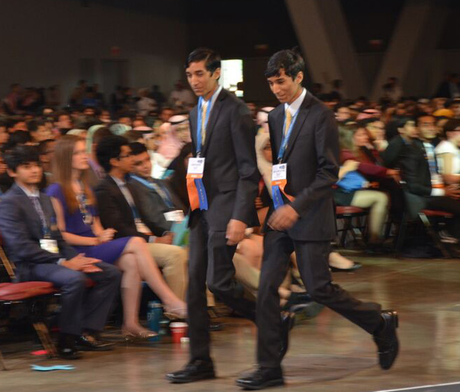 The Dholakia brothers walking up to receive their $3,000 First Award in Physics at Intel ISEF 2015.