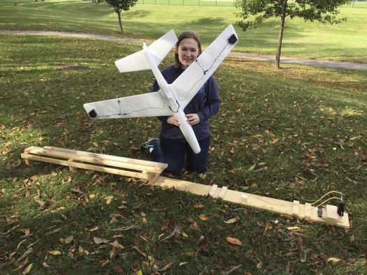 Rachel experimenting with a model plane she made