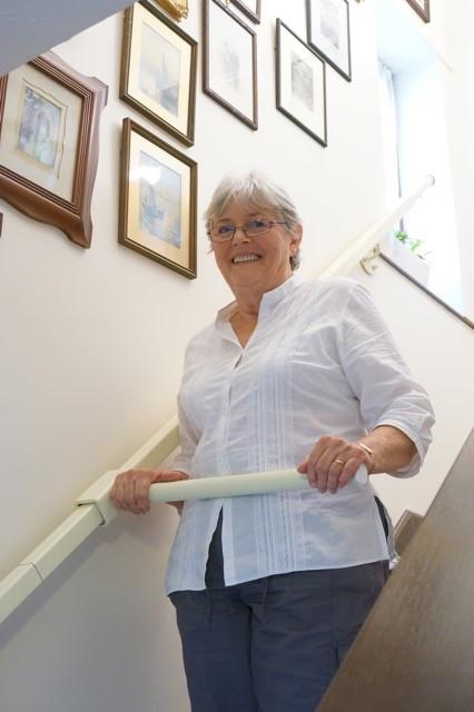 A woman uses the StairSteady, invented by Ruth Amos. 