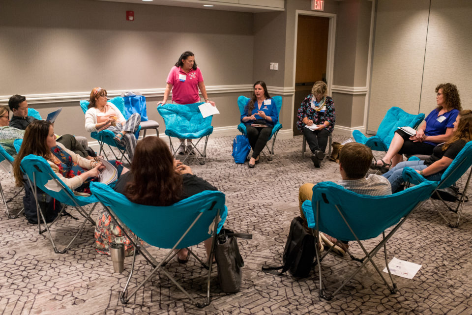 Teachers at the High School Research Teacher's Conference having a discussion