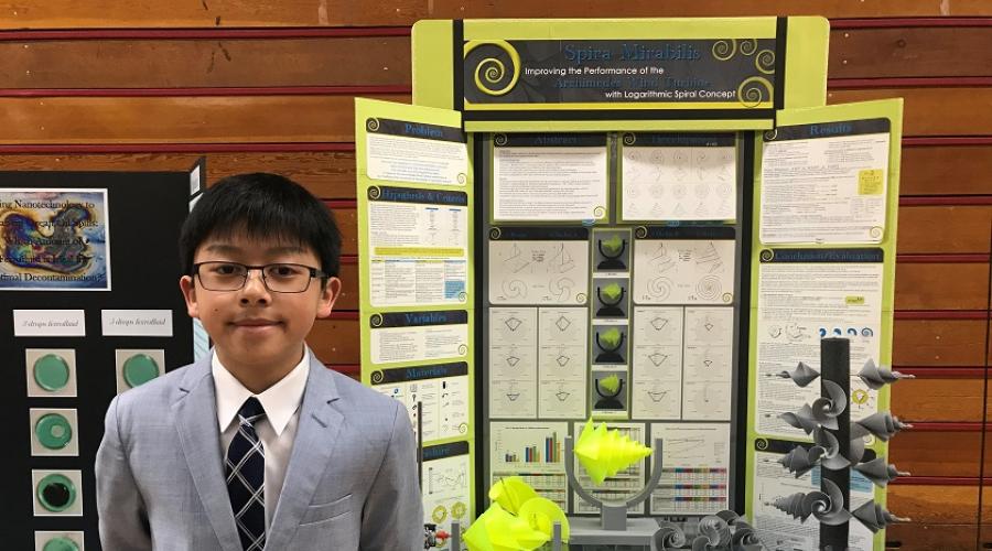 Jordan in front of his project board at a local science fair.