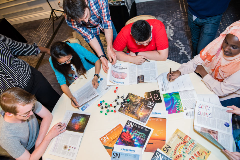 Students reading Science News