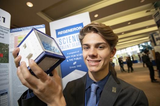 Braden holding his SymBeads during the 2019 Regeneron STS public showcase of projects.