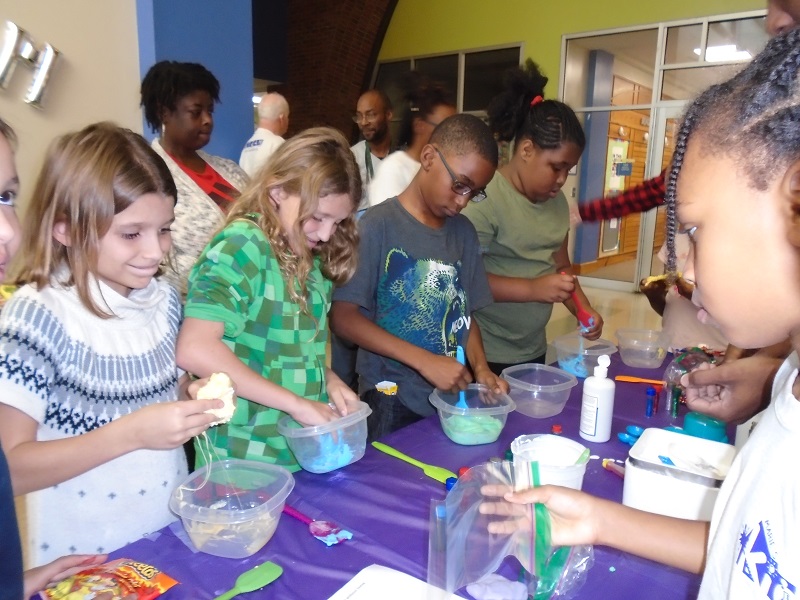 Participants of Marie's Kids STEAM Night making slime