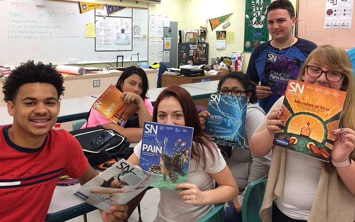 Students in classroom with Science News magazine