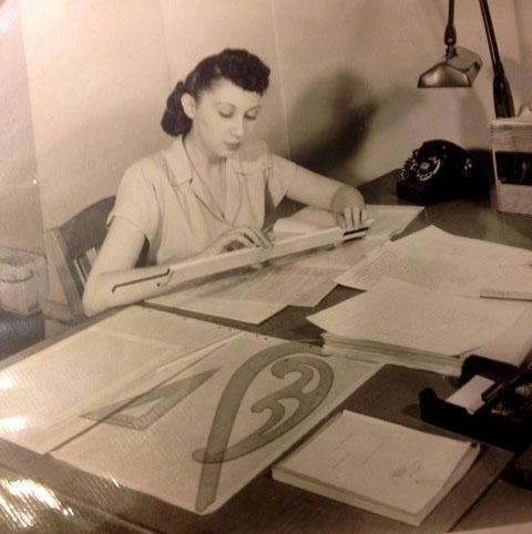 Carol Bauer in 1947 at Hydrocarbon Research, using a slide rule and drafting tools.