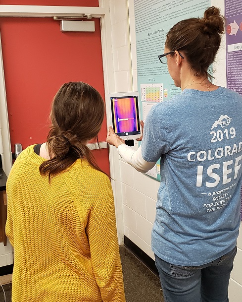 Amy (right) showing a junior student how to use the thermal imaging camera on the iPad.