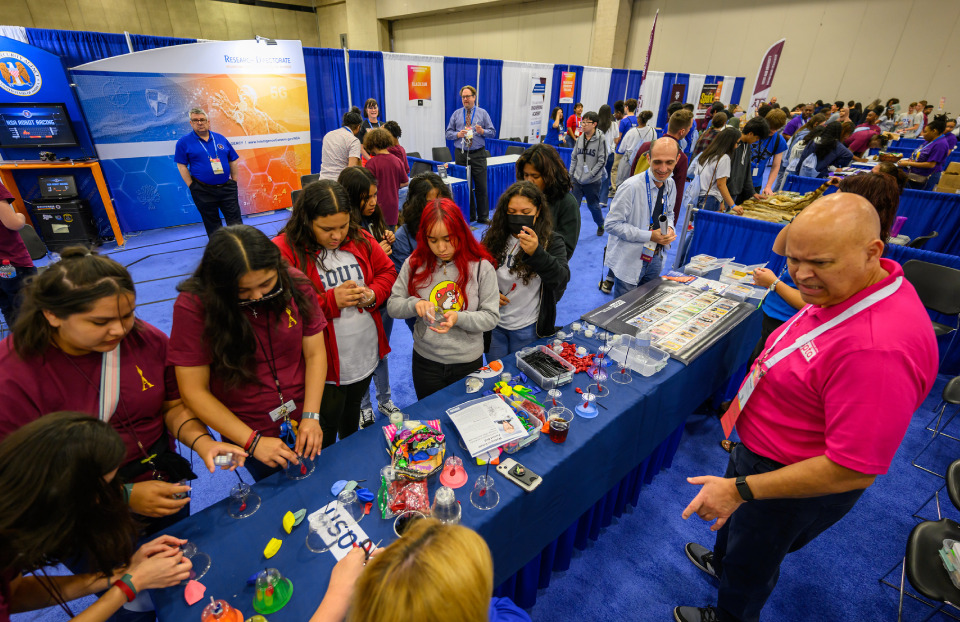 Exhibitors speaking to local students at Regeneron ISEF 2023 in Dallas, Texas during Education Outreach Day.