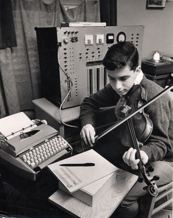 A young Ray Kurzweil plays a composition on the violin written by his music composing program for the Science Talent Search.