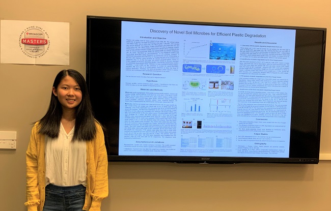 Broadcom MASTERS 2020 finalist Angela Zhan in front of her project displayed on a screen