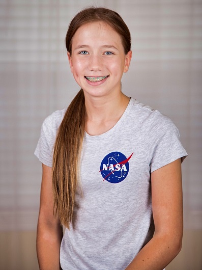 headshot of student Maya Trustchl against backdrop