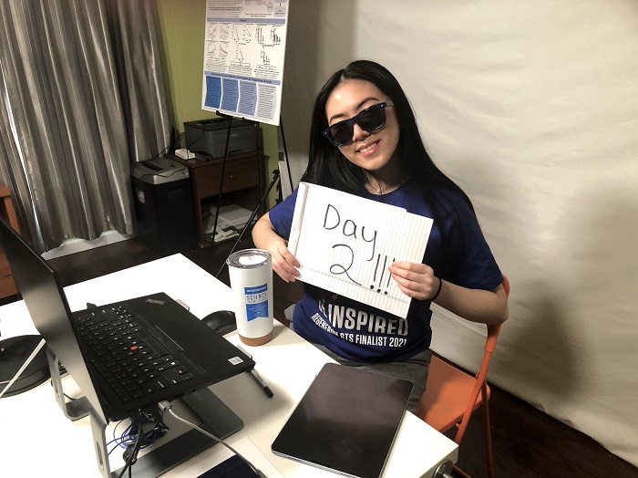 Regeneron STS 2021 finalist Vivian Yee with "Day 2" sign 