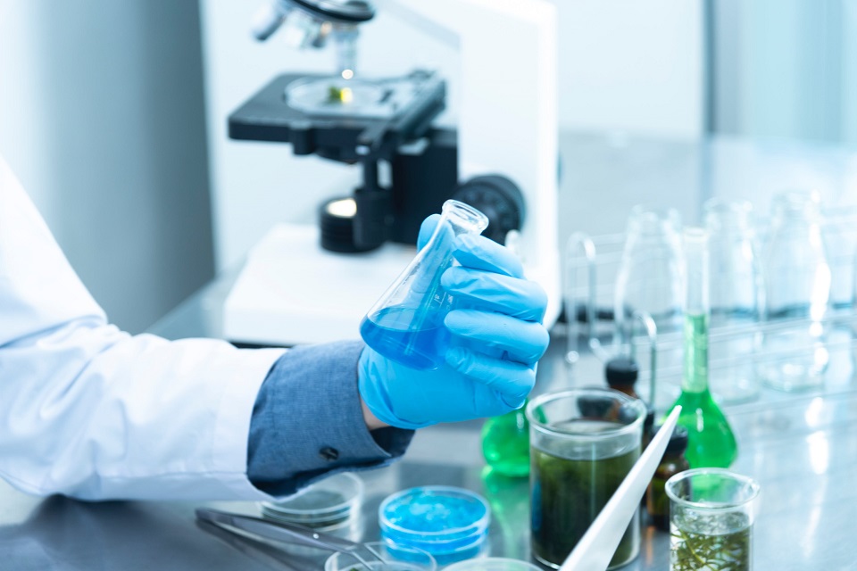 person holding lab flask