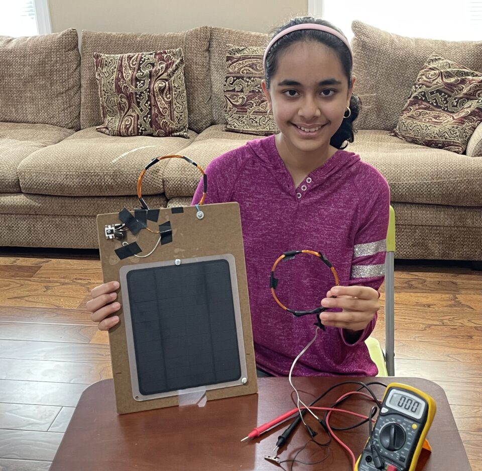 Shriya Tailor holding her invention's prototype.