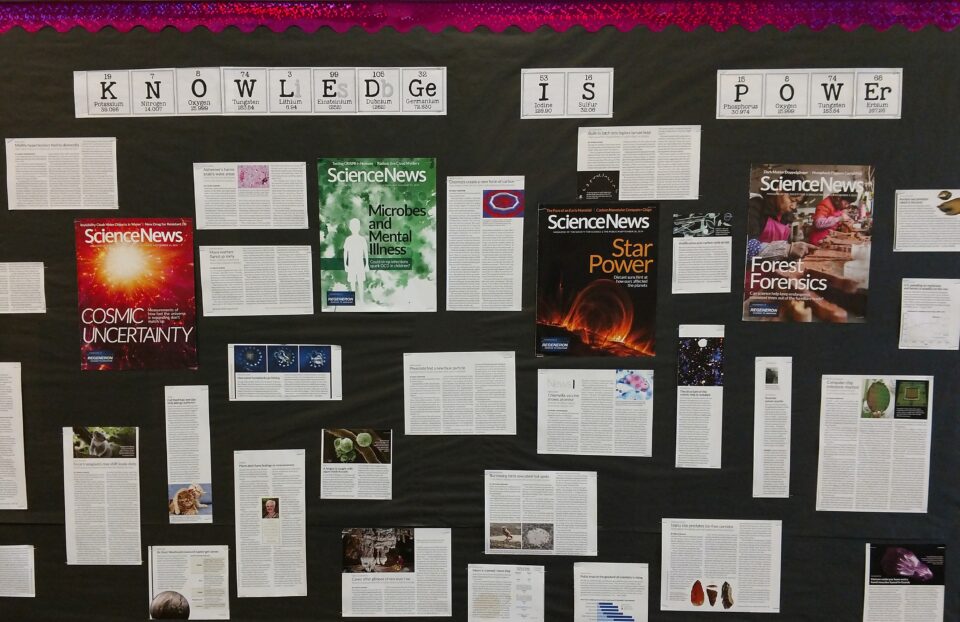 A classroom bulletin board with a heading reading, "Knowledge is Power," with Science News articles posted below
