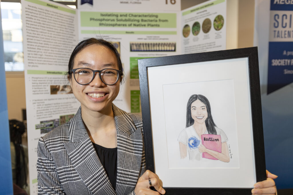 Krystal Li poses with her self portrait during Public Day.