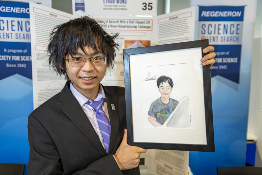 Ethan Wong poses with his self portrait during Public Day