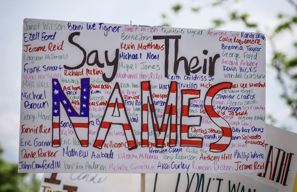 A sign at a protest that reads, "Say Their Names"