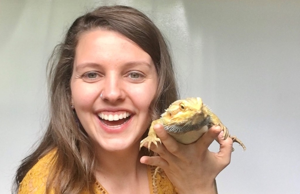 Elizabeth Bieri smiling and holding a lizard