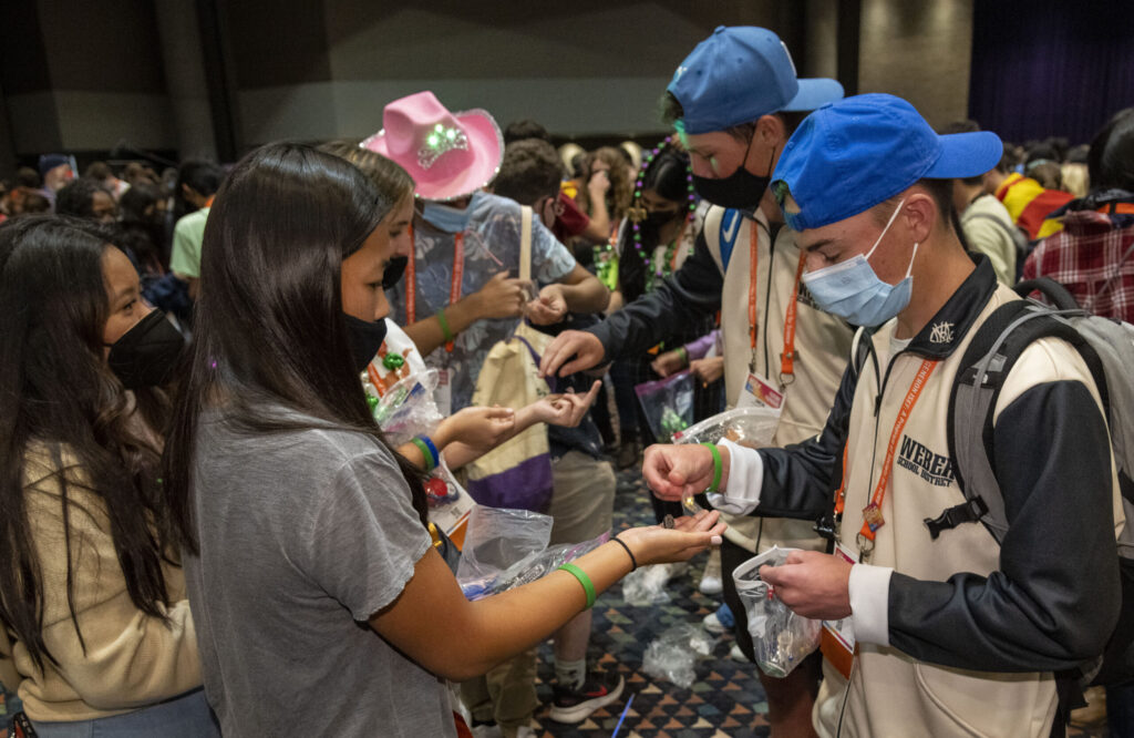 2022 Regeneron ISEF finalists exchange pins and laughs during the pin exchange.