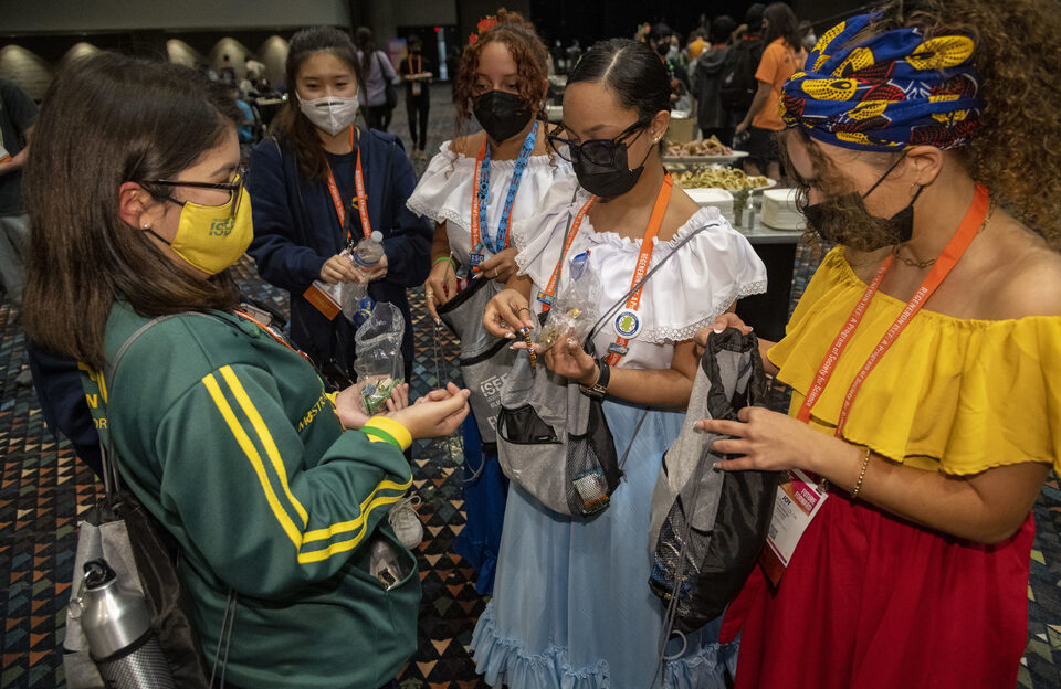 Finalists from Brazil and Puerto Rico exchange pins during the 2022 Regeneron ISEF Pin Exchange