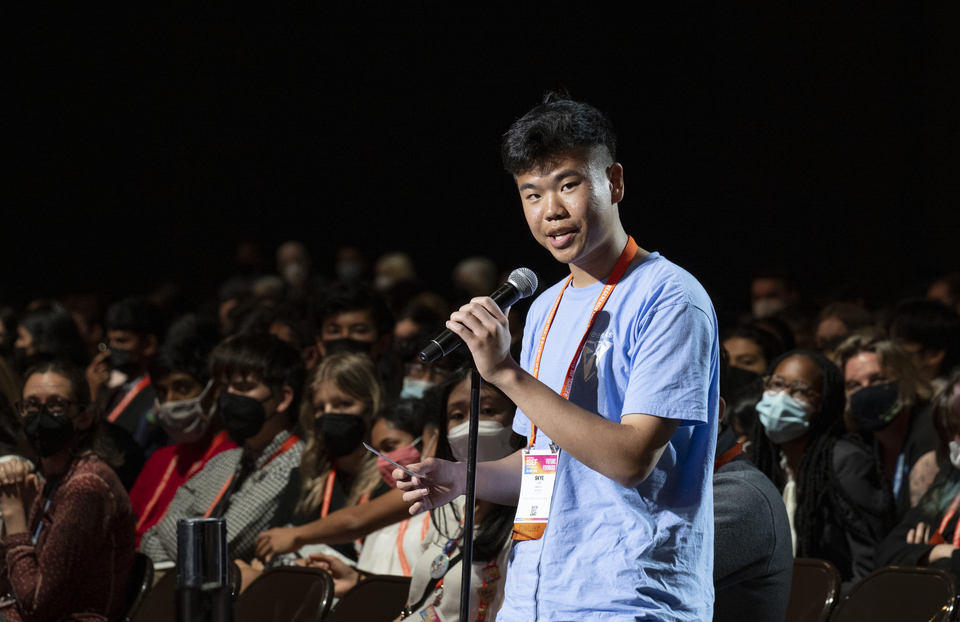 A student asks a question into a microphone during a Q&A session at Regeneron ISEF 2022