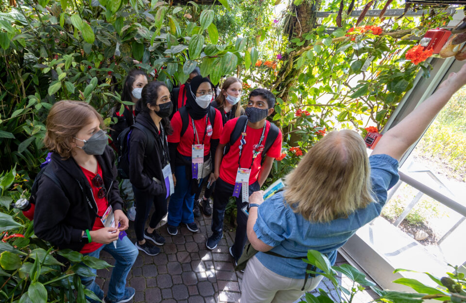 A group of 2022 Broadcom MASTERS International delegates learn about plants during a field trip in Atlanta, Georgia