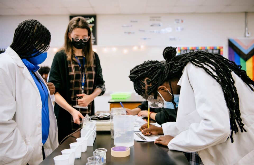 A Society for Science Advocate observes students doing research in a school lab.